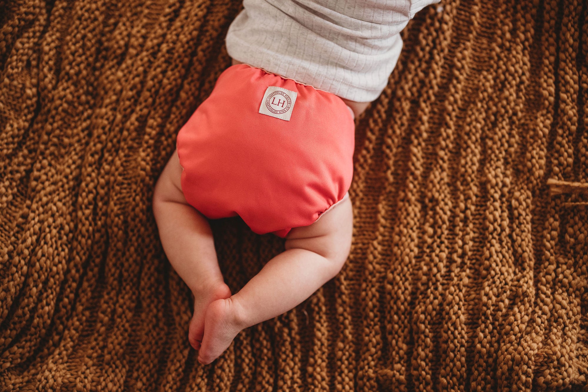 Lighthouse Kids Co. cloth diaper covers have leg gussets to keep messes contained.  Voted best cloth diaper brand for AI2 cover diapers.  Small mom-run business in Iowa City, IA