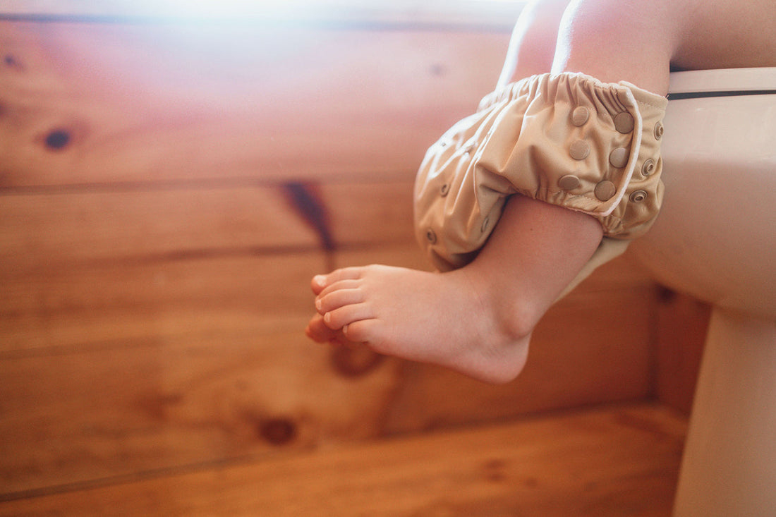 Do Cloth Diapers Help with Potty Training?  Toddler Sitting in a Potty