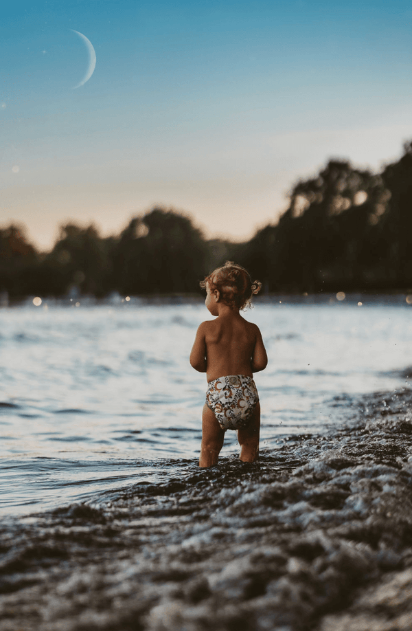 Cloth Diapered Baby on the Beach Wearing an AIO Cloth Diaper