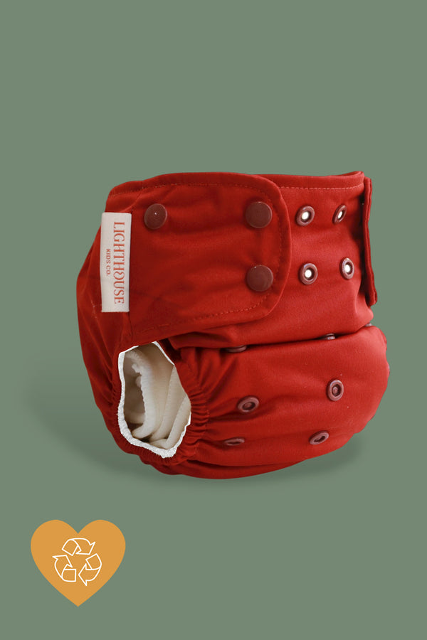 Red cloth diaper with white inside and snaps, All-in-One cloth diapers, AIO by Lighthouse Kids company