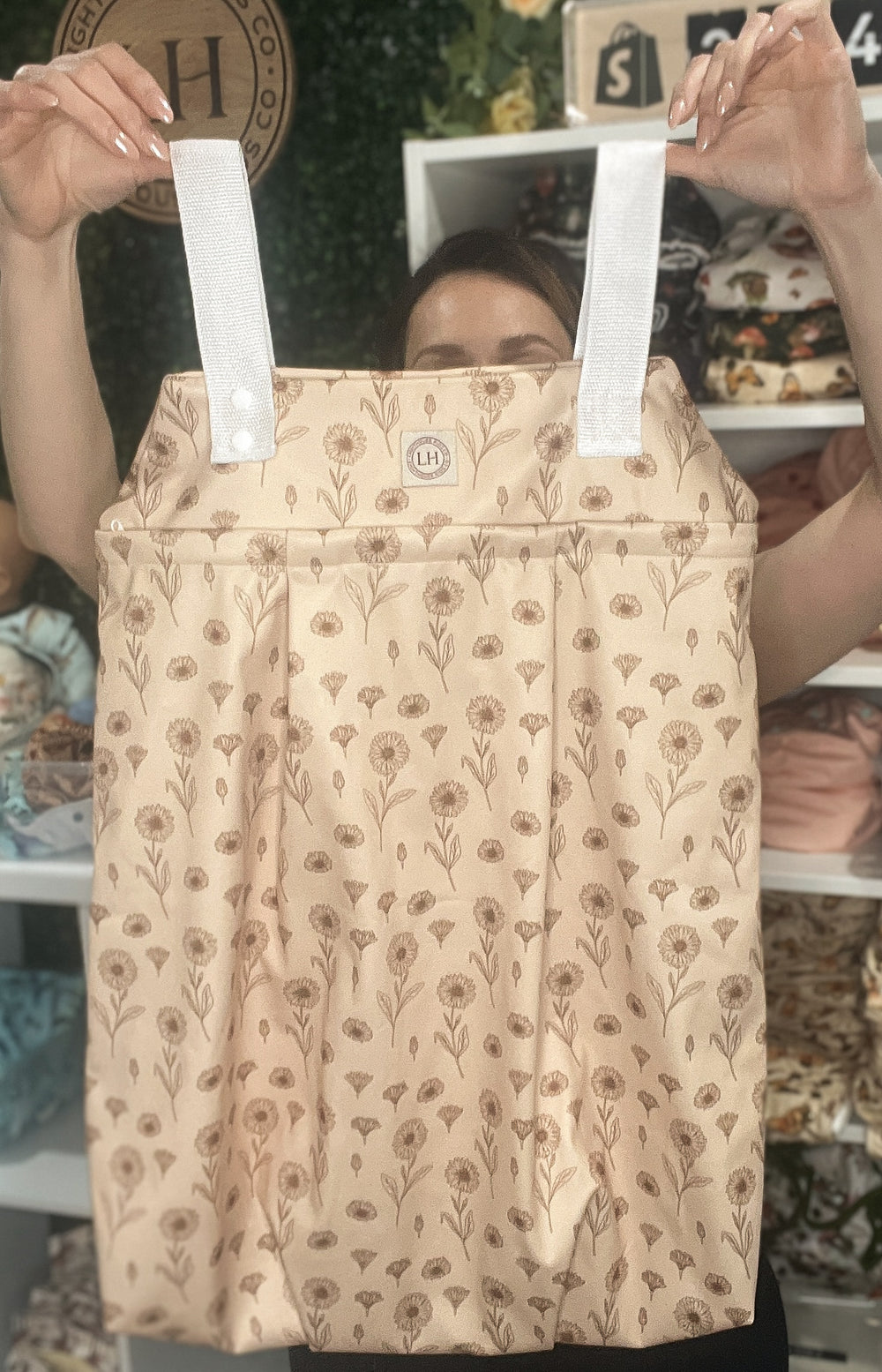 The Lighthouse Kids Company Hanging Diaper Pail is a great solution for storing cloth diapers between washes. 
 Made with 2 heavy-duty layers of recycled TPU, this pail liner keeps smells in and holds approximately 30 cloth diapers. Great for traveling and long outings.  Print Safari