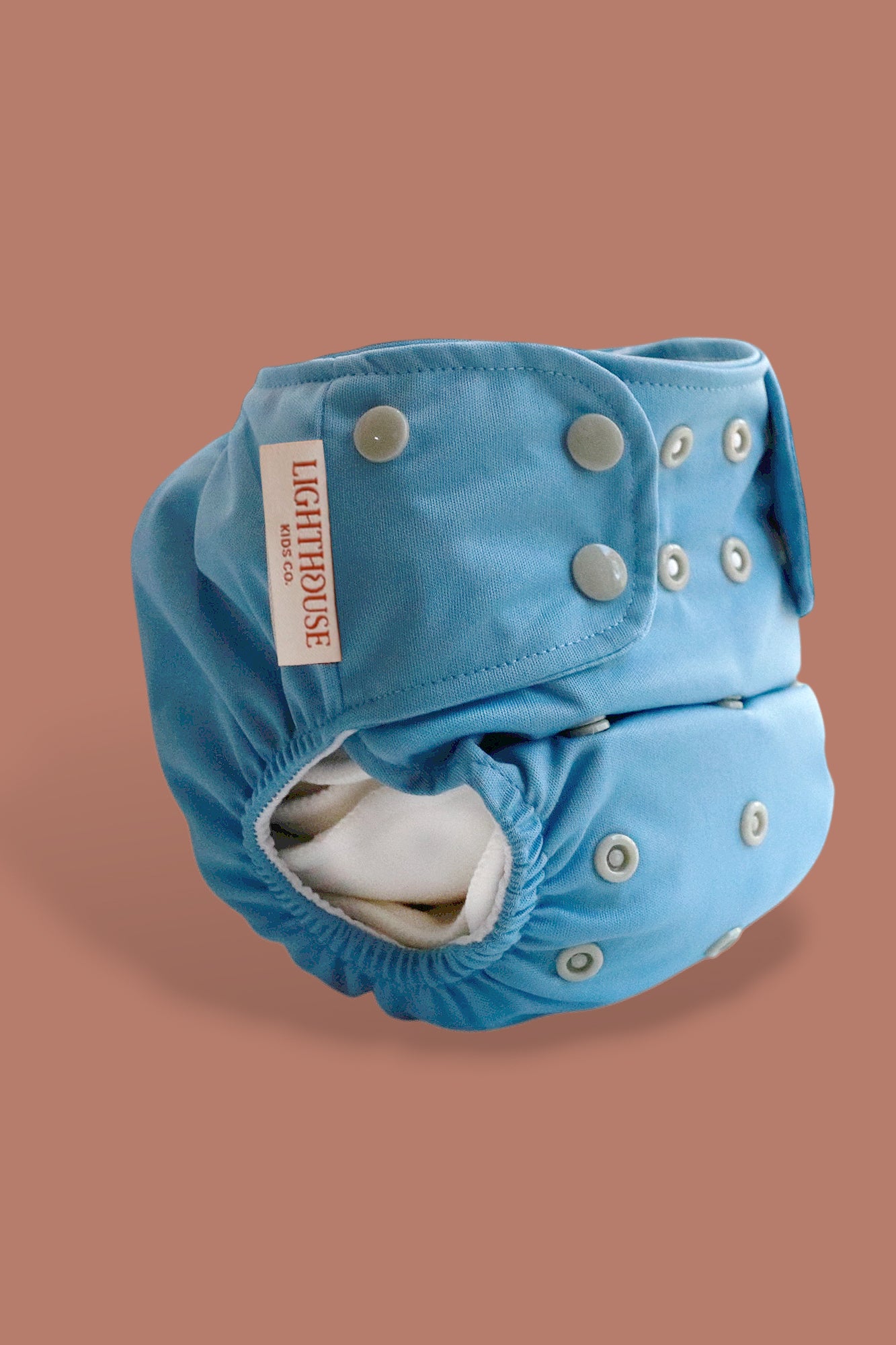 Blue all in one AIO cloth diaper with button closure by Lighthouse Kids Company
