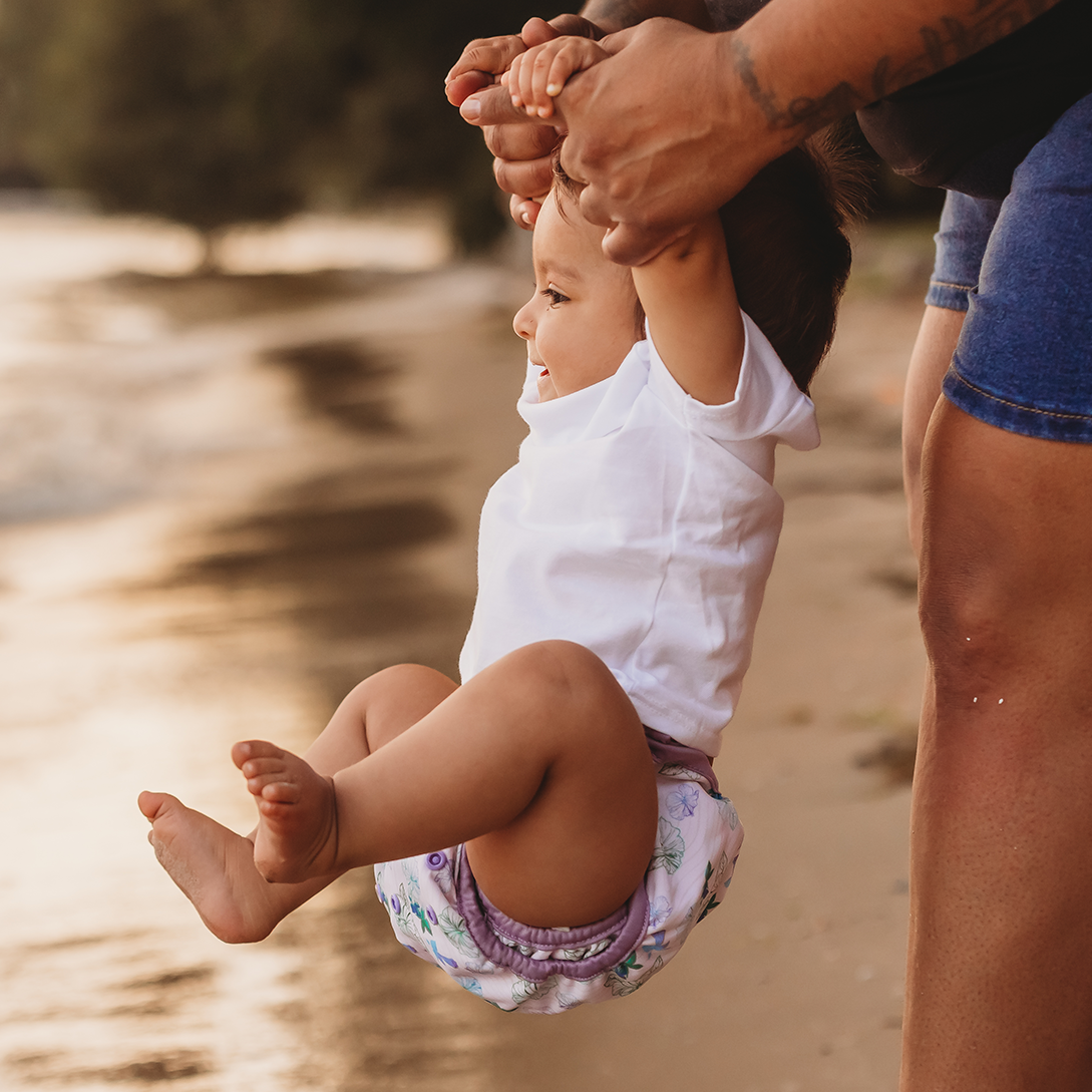 baby at the beach wearing cloth diaper cover by lighthouse kids company
