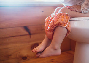 Reusable Potty Training Pants for toddlers sitting on toilet by Lighthouse Kids Company