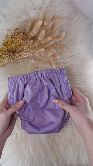 Video demonstrating how toddlers pull on reusable potty training pants independently